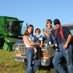 Farmer with family by pickup truck